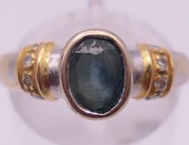 An 18 K white gold, diamond and sapphire ring. Ring size M/N. 4.9 grammes total weight.