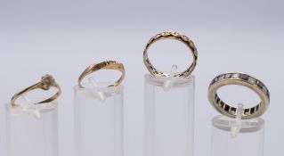 Two 9 ct gold rings 2.4 grammes total weight, an unmarked eternity ring and a silver eternity ring.