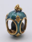 A silver gilt elephant and egg pendant bearing Russian marks. 2.5 cm high.
