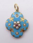 A Victorian unmarked 18 ct gold and blue enamel locket. 3 cm high. 3.3 grammes total weight.
