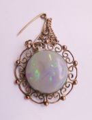 A 9 ct gold and opal brooch. 2.5 cm diameter.