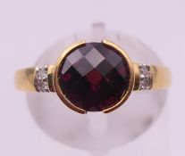 An 18 ct gold, diamond and garnet ring. Ring size N/O. 3.2 grammes total weight.