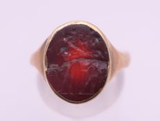 An unmarked gold intaglio ring. Ring size M.