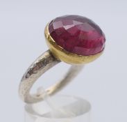 A pink tourmaline, gold and silver ring by Poppy Dandiya. Ring size N/O.