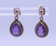 A pair of 9 ct gold and amethyst earrings. 1 cm high.