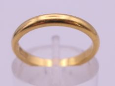 A 22 ct gold wedding band. Ring size K. 3.4 grammes.