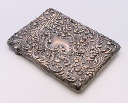 A silver card case with embossed scroll and floral decoration. 10 x 7.5 cm.
