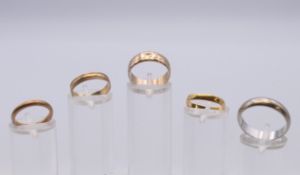 Three 9 ct gold wedding bands 6.3 grammes, an 18 ct white gold wedding band 6.