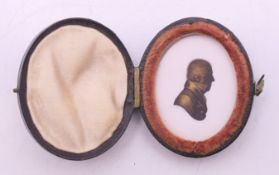 A miniature gilded silhouette portrait of a gentleman by Miers & Field, in original leather case. 4.