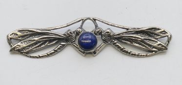 A silver and lapis lazuli dragonfly brooch. 9 cm wide.