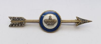 A diamond and enamel arrow brooch bearing Russian marks. 7.5 cm wide.