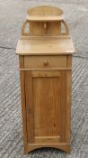 A 19th century pine bedside cupboard. 94 cm high.