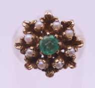 A 9 ct gold, emerald and seed pearl ring. Ring size K/L. 4.8 grammes total weight.