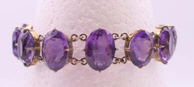A silver gilt and amethyst bracelet. 18 cm long.