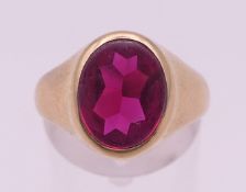 A gold and ruby ring in an associated box. (Mozambique ruby) Ring size O. 6.5 grammes.