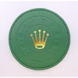 A boxed Rolex coaster. 10 cm diameter.