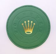A boxed Rolex coaster. 10 cm diameter.