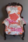 A Victorian mahogany-framed armchair with brightly-coloured upholstery. 74 cm wide.