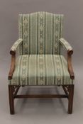 An early 20th century green upholstered mahogany armchair. 65 cm wide.