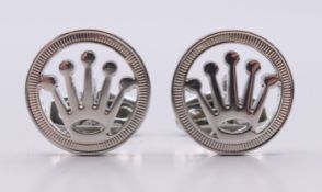 A boxed pair of Rolex cufflinks with certificate of origin. 2 cm diameter.