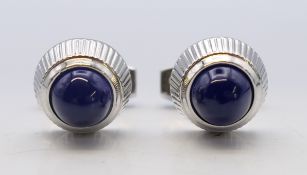 A pair of cufflinks stamped 'Cartier' in an associated box. 1.5 cm diameter.
