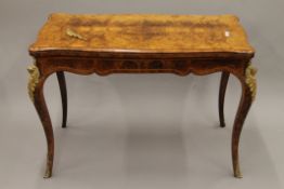 A Victorian ormolu-mounted burr walnut card table. 105 cm long.