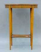 A Victorian painted satinwood side table. 56 cm wide.