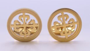 A pair of Patek Philippe cufflinks in a Hackett, London box with certificate of origin.
