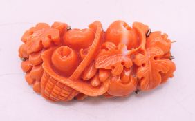 A coral and silver gilt brooch. 4.5 cm x 2.25 cm.