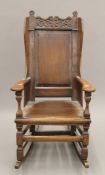 A 18th century-style oak rocking chair. 62 cm wide.