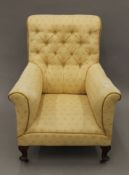 An early 20th century upholstered armchair. 76 cm wide.
