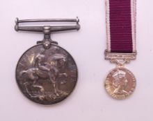 An Elizabeth II Regular Army Long Service and Good Conduct medal with ribbon and a George V