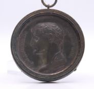 A Napoleon lead medallion in a metal pendant frame. 7 cm diameter.
