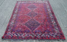 A dark red ground rug. 178 x 225 cm.