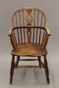 A 19th century elm seated Windsor chair. 52 cm wide.