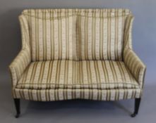 An Edwardian upholstered twin-seater settee. 125 cm wide.