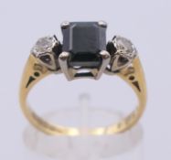 An 18 ct gold three-stone dress ring. Ring size M/N.