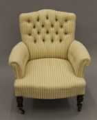 A Victorian yellow and green upholstered button back armchair. 73 cm wide.