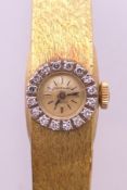 An 18 ct gold and diamond Universal Geneva ladies' cocktail wristwatch,