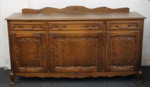 A Continental oak sideboard. 197 cm long x 101 cm high at front x 55 cm deep.