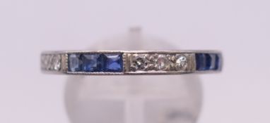 A sapphire, diamond and white metal eternity ring. Ring size S/T.