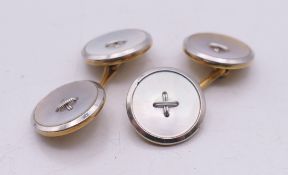 A pair of 18 ct gold, platinum and mother-of-pearl cufflinks. 1.5 cm diameter. 7.