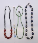 Three bead necklaces and a green single-strand bead necklace with matching bracelet.