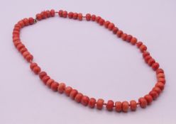 A single strand of coral beads with a 9 ct gold clasp. 60 cm long.