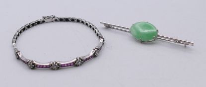 A silver and jade bar brooch and a bracelet. Bracelet 17 cm long.