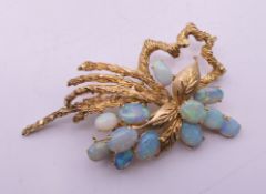 A 14 K gold and opal floral spray brooch. 5.5 x 3.5 cm. 12.2 grammes total weight.
