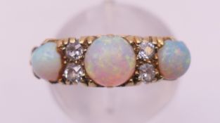An 18ct gold, diamond and opal ring. Ring size J/K. 4.6 grammes total weight.