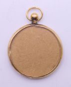 A 9 ct gold pendant photograph frame. 2.5 cm diameter.