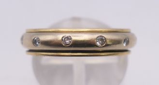 An 18 ct bi-colour gold and diamond-set wedding band. 0.5 cm high, ring size O/P. 5.