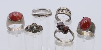 Six silver rings.